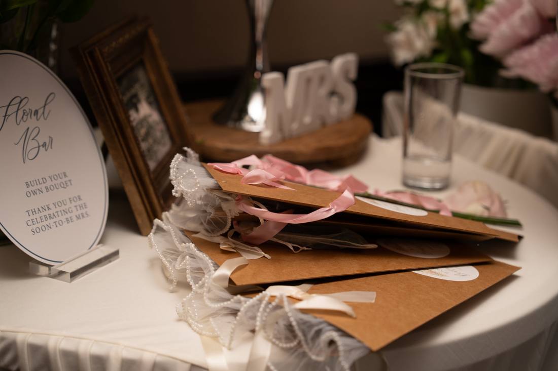 Kraft bouquet bags trimmed with pearls and pink and ivory satin ribbons