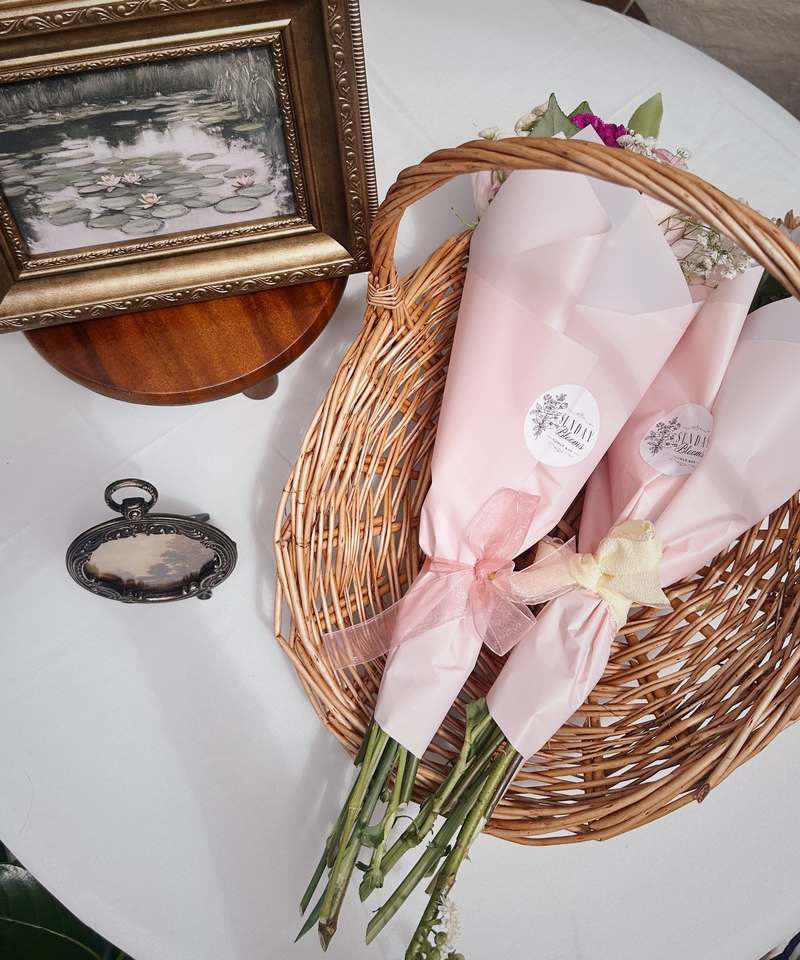 Sunday Blooms signature pink bouquet wraps in a wicker basket